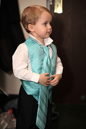 Young boy tries on dad's tie before Nashville wedding ceremony